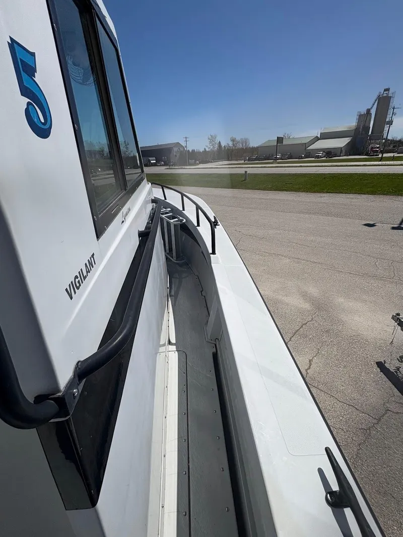 Slide: The Image of 2002 Boston Whaler 27 Vigilant boat docked, side view with clear sky. - 4