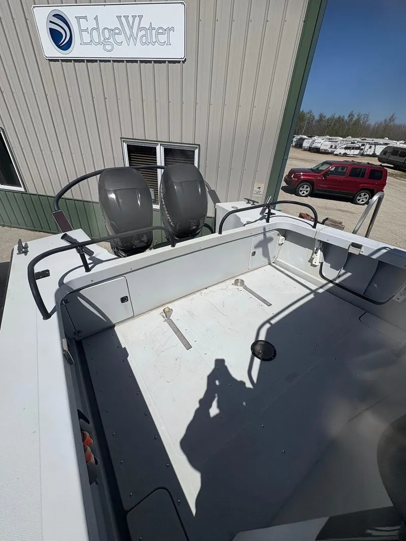 Slide: The Image of 2002 Boston Whaler 27 Vigilant boat at EdgeWater facility with dual outboard motors. - 9