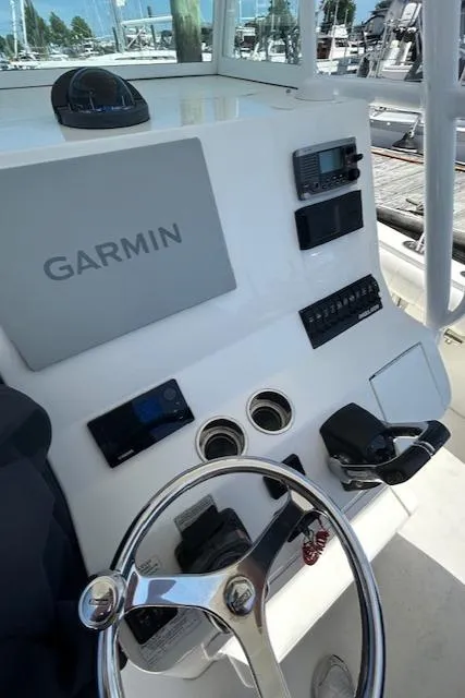 Slide: The Image of 2013 Regulator 26 FS boat dashboard with Garmin navigation system and steering wheel. - 12