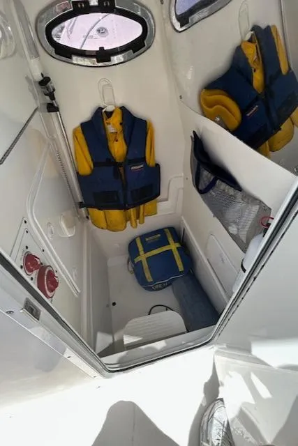 Slide: The Image of Interior of 2013 Regulator 26 FS boat with life jackets and storage. - 13