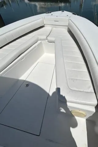 Slide: The Image of 2013 Regulator 26 FS boat with spacious white seating and sleek design. - 15