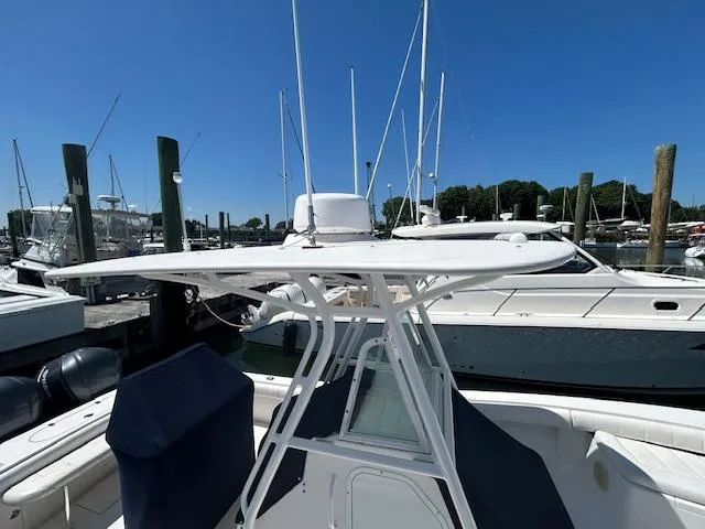 Slide: The Image of 2013 Regulator 26 FS boat docked at marina under clear blue sky. - 8