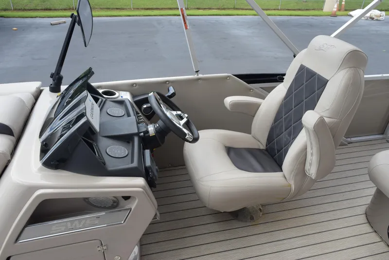 Slide: The Image of 2022 Silver Wave 2410 SW5 JS boat interior with captain's chair and control panel. - 11