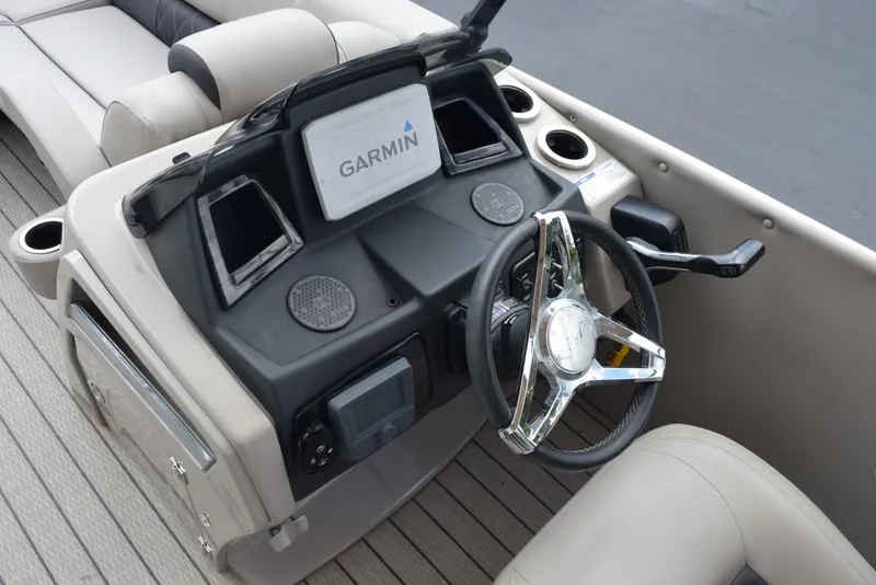 Slide: The Image of 2022 Silver Wave 2410 SW5 JS boat dashboard with Garmin navigation system and steering wheel. - 12