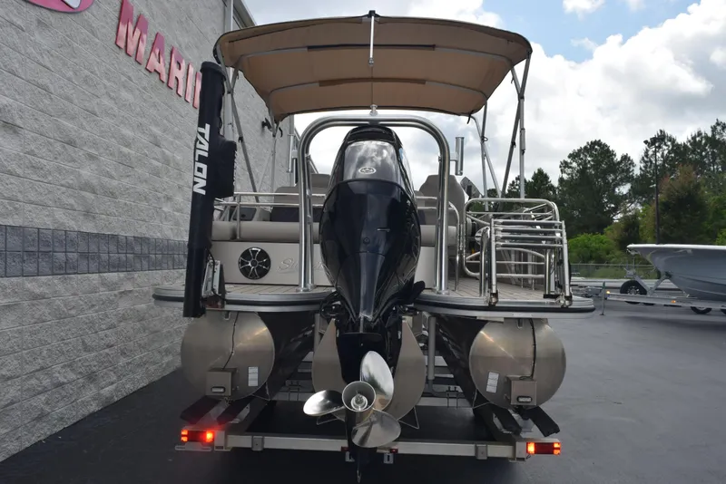 Slide: The Image of 2022 Silver Wave 2410 SW5 JS pontoon boat, rear view with motor and canopy. - 5