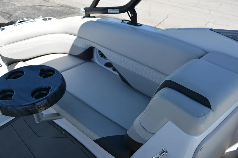 Slide: The Image of 2022 Hurricane SunDeck 2690 OB boat interior with cushioned seating and cup holders. - 16