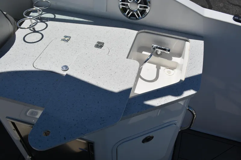 Slide: The Image of 2022 Hurricane SunDeck 2690 OB boat kitchenette with sink and countertop. - 18