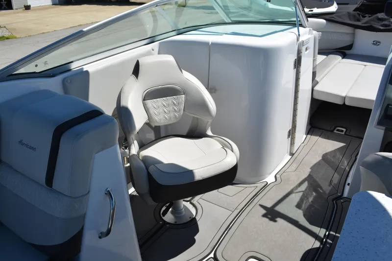 Slide: The Image of 2022 Hurricane SunDeck 2690 OB boat interior with swivel captain's chair and sleek design. - 20