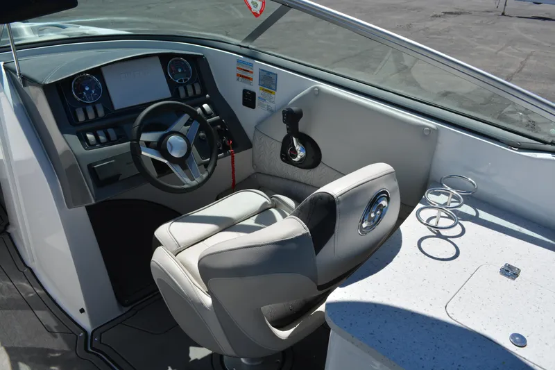 Slide: The Image of 2022 Hurricane SunDeck 2690 OB boat cockpit with steering wheel and seating. - 21