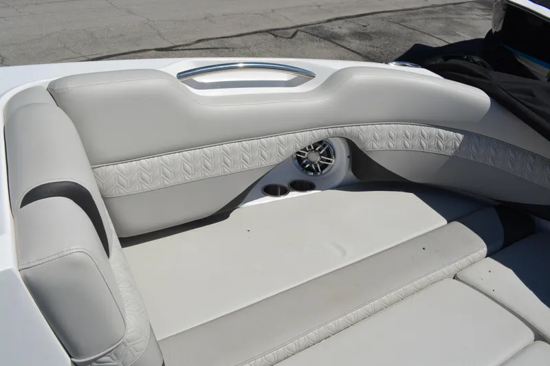 Slide: The Image of 2022 Hurricane SunDeck 2690 OB boat interior with cushioned seating and speaker. - 24