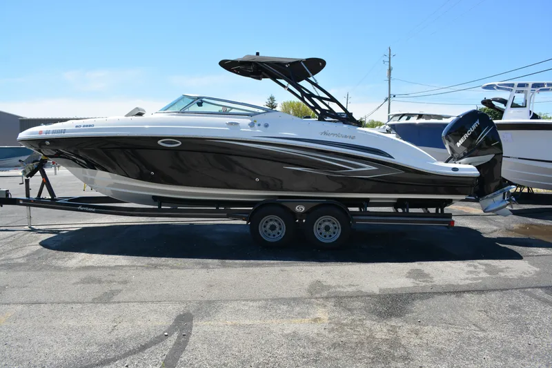 Slide: The Image of 2022 Hurricane SunDeck 2690 OB boat on trailer, side view, outdoors. - 5