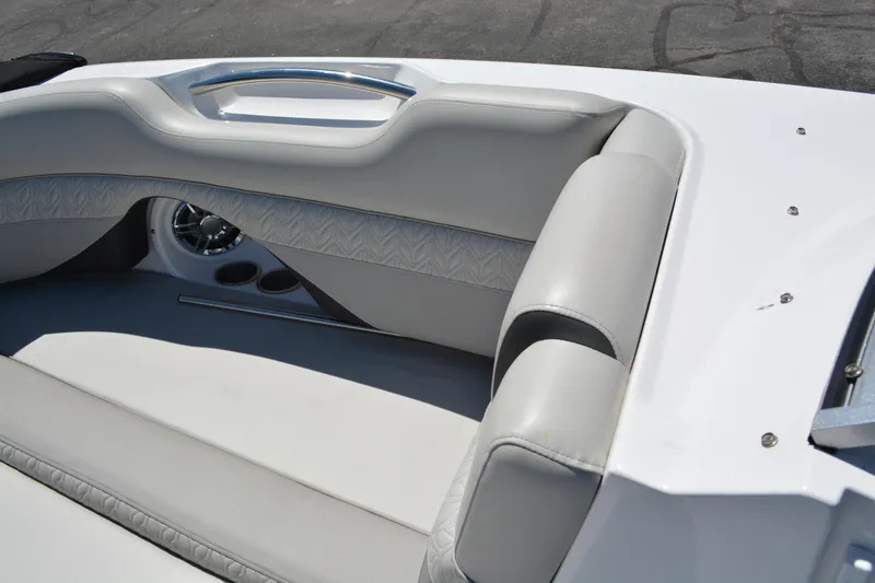 Slide: The Image of 2022 Hurricane SunDeck 2690 OB boat interior with white cushioned seating and cup holders. - 8