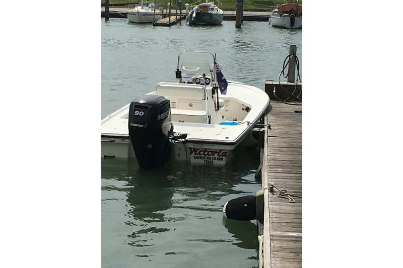 Slide: The Image of 2016 Mako 18 LTS boat docked with Mercury 90 engine in marina. - 11