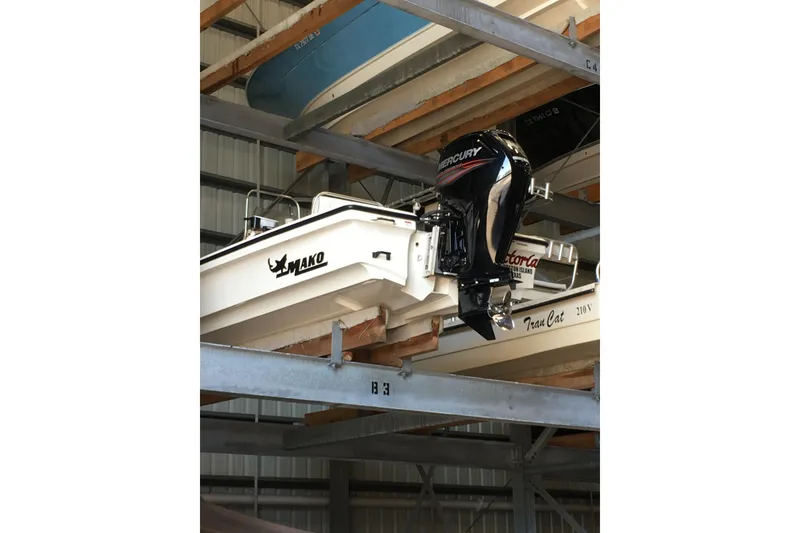 Slide: The Image of 2016 Mako 18 LTS boat with Mercury outboard motor in storage rack. - 7