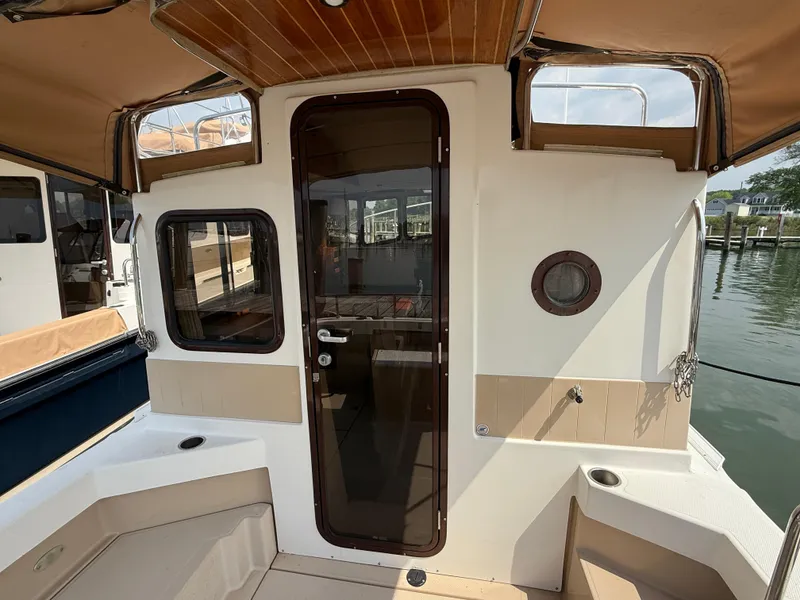 Slide: The Image of 2017 Ranger Tugs R-27 boat interior with glass door and seating area. - 6