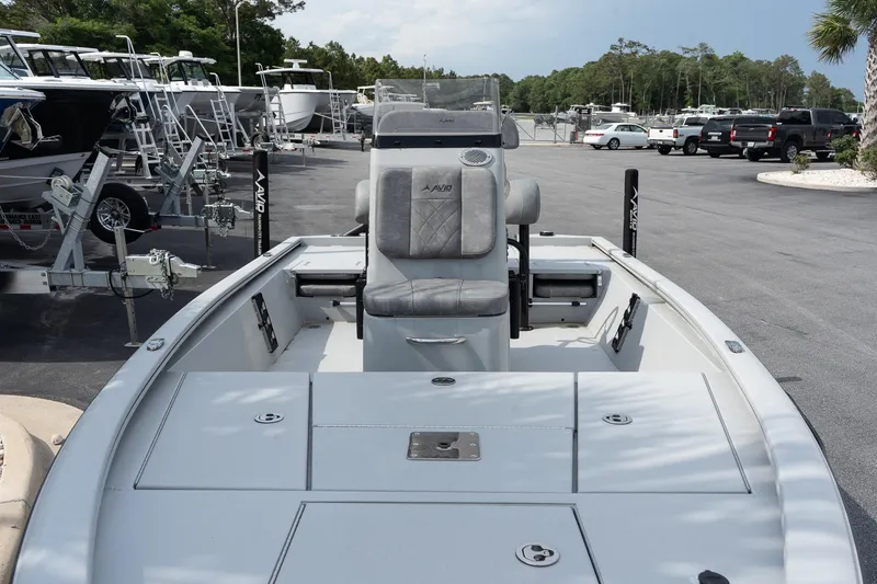 Slide: The Image of 2025 Avid 19 FSX boat in a marina, showcasing sleek design and seating. - 11