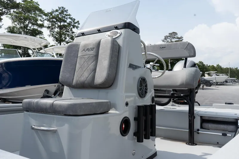Slide: The Image of 2025 Avid 19 FSX boat interior with cushioned seating and steering console. - 8