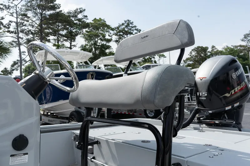 Slide: The Image of 2025 Avid 19 FSX boat interior with steering wheel and Yamaha outboard motor. - 9