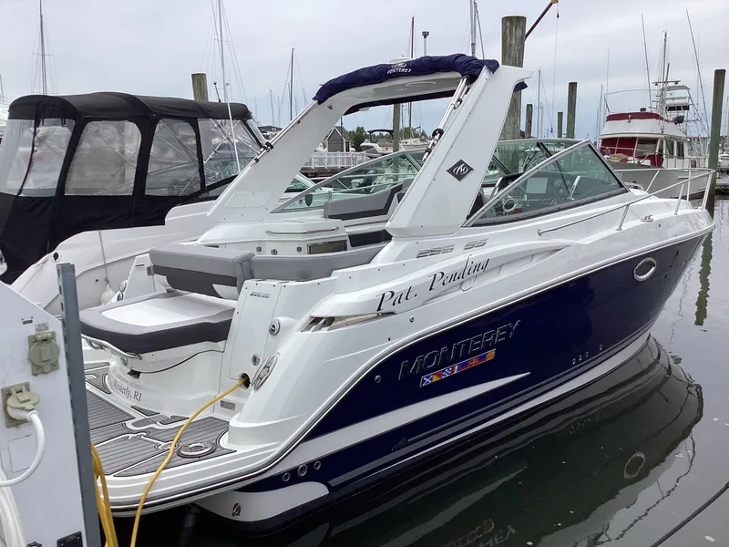 Slide: The Image of 2022 Monterey 295 Sport Yacht docked at marina, featuring sleek design and modern amenities. - 10