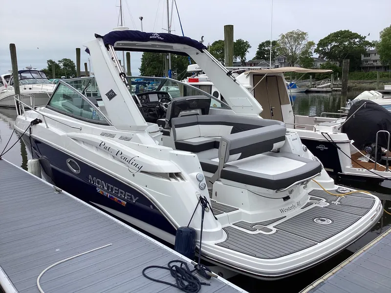 Slide: The Image of 2022 Monterey 295 Sport Yacht docked, featuring sleek design and spacious seating. - 25