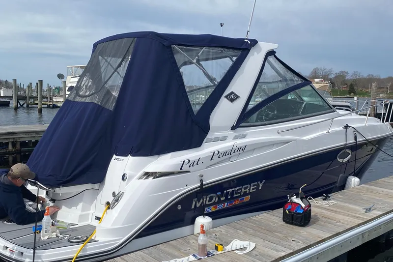 Slide: The Image of 2022 Monterey 295 Sport Yacht docked with blue canopy and accessories. - 3