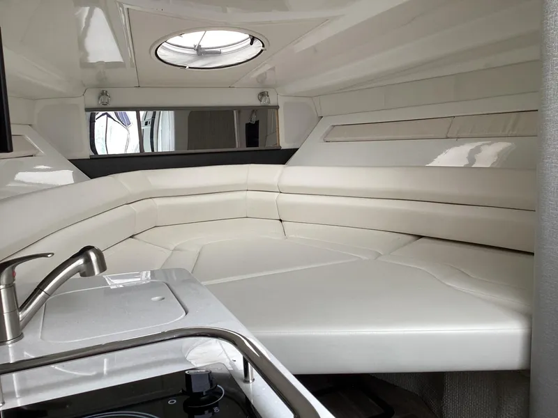 Slide: The Image of Luxurious interior of 2022 Monterey 295 Sport Yacht with white seating and modern amenities. - 31