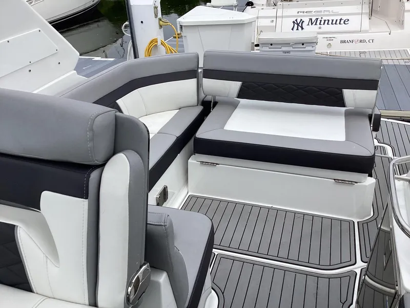 Slide: The Image of Luxury seating on 2022 Monterey 295 Sport Yacht, featuring sleek gray and white upholstery. - 34
