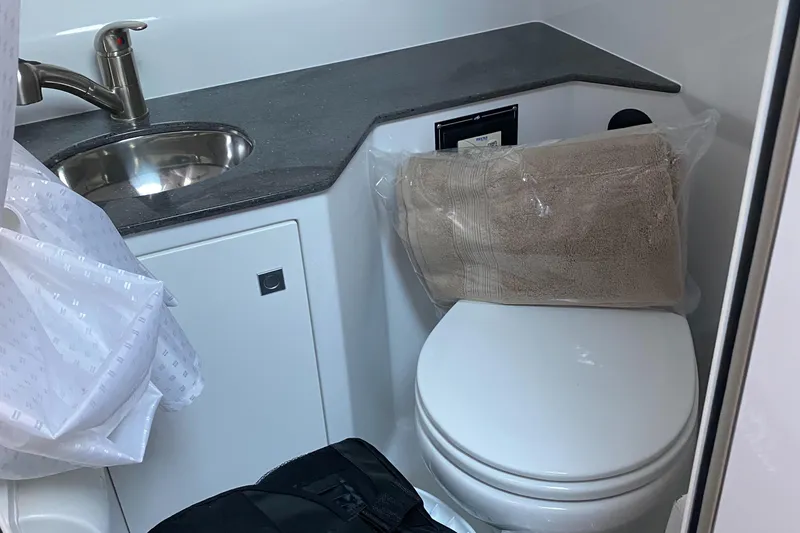 Slide: The Image of 2022 Monterey 295 Sport Yacht bathroom with sink, countertop, and toilet. - 6