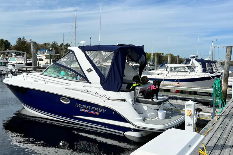 Slide: The Image of 2022 Monterey 295 Sport Yacht docked at marina with blue canopy. - 8