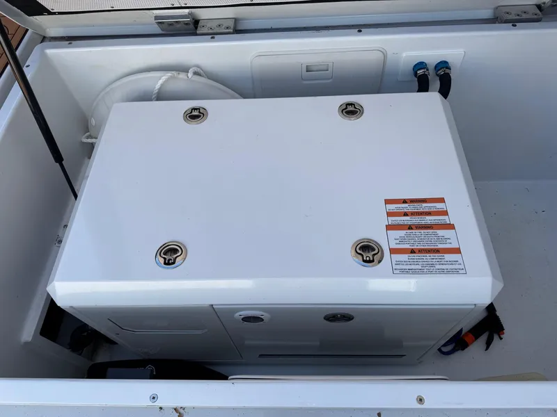 Slide: The Image of Engine compartment of 2020 Coastal Craft 33 Express boat, featuring a white generator. - 11