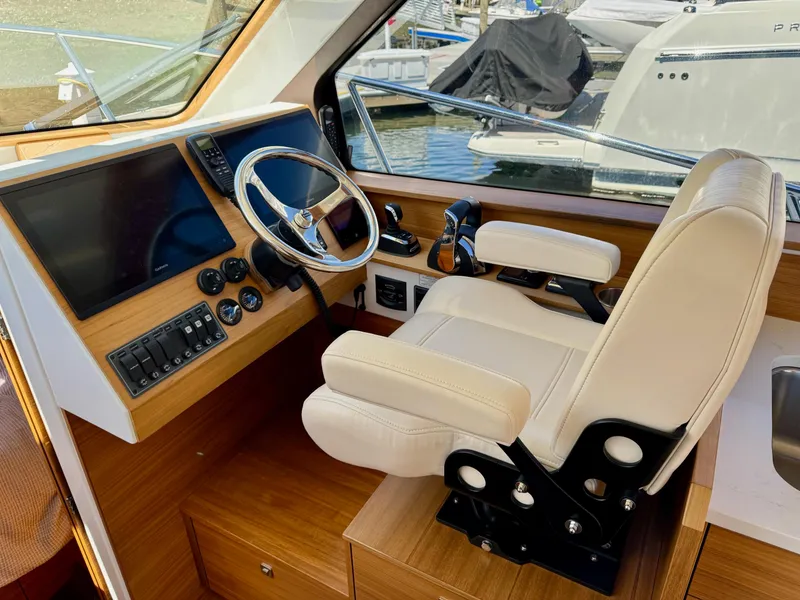 Slide: The Image of 2020 Coastal Craft 33 Express helm with modern controls and comfortable captain's chair. - 13