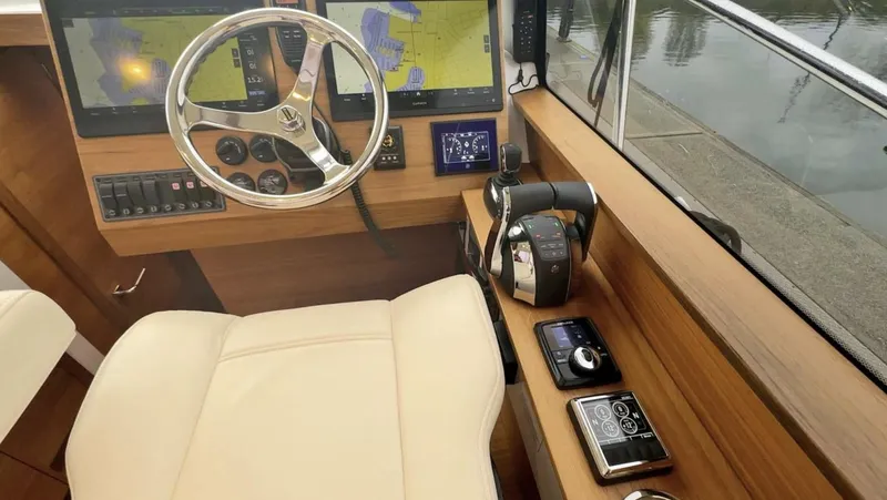 Slide: The Image of Helm of 2020 Coastal Craft 33 Express with navigation screens and controls. - 14