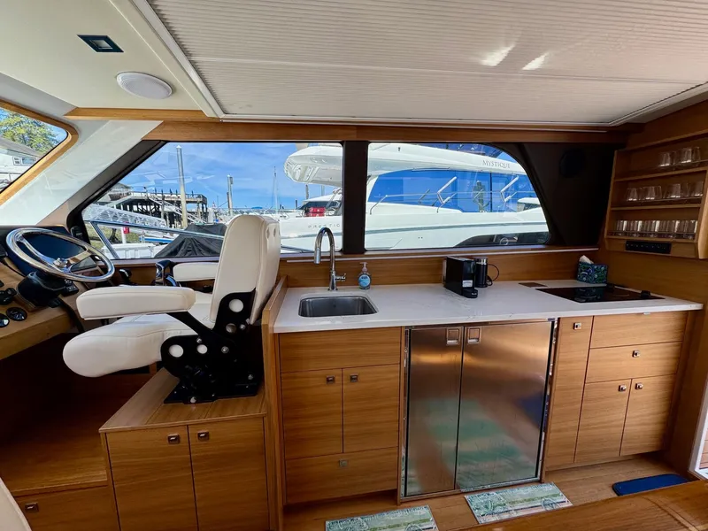 Slide: The Image of Interior of 2020 Coastal Craft 33 Express yacht with helm, sink, and cabinetry. - 17