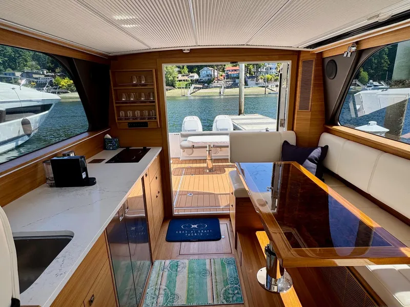 Slide: The Image of Interior of 2020 Coastal Craft 33 Express yacht with modern kitchen and dining area. - 18