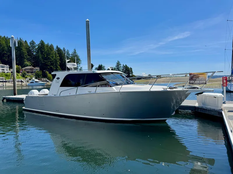 Slide: The Image of 2020 Coastal Craft 33 Express yacht docked in a serene marina setting. - 2