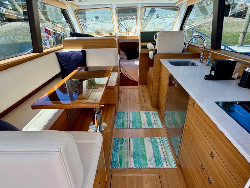 Slide: The Image of Interior of 2020 Coastal Craft 33 Express yacht with modern kitchen and seating area. - 21