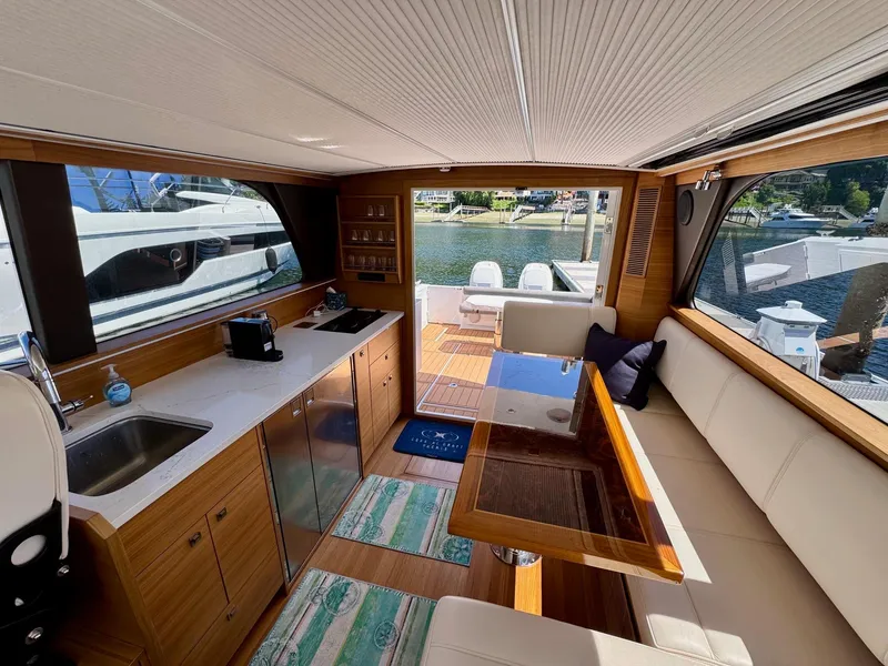 Slide: The Image of Interior of 2020 Coastal Craft 33 Express yacht with modern kitchen and seating area. - 24