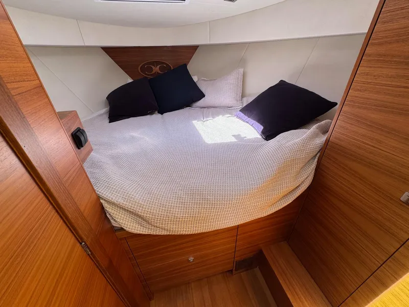 Slide: The Image of Cozy cabin interior of 2020 Coastal Craft 33 Express with wooden finish and comfortable bedding. - 29