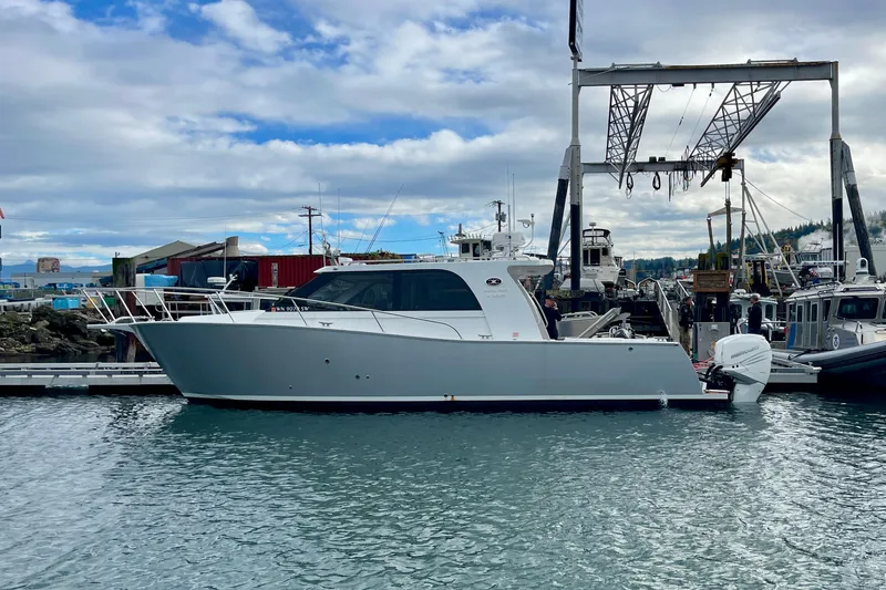 Slide: The Image of 2020 Coastal Craft 33 Express yacht docked at marina under cloudy sky. - 3