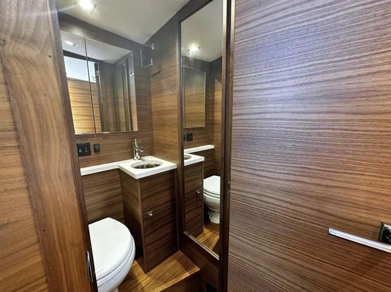 Slide: The Image of Luxurious bathroom in 2020 Coastal Craft 33 Express yacht with wood paneling and modern fixtures. - 30