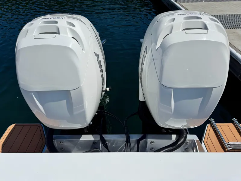 Slide: The Image of Twin outboard engines on a 2020 Coastal Craft 33 Express boat at a dock. - 32