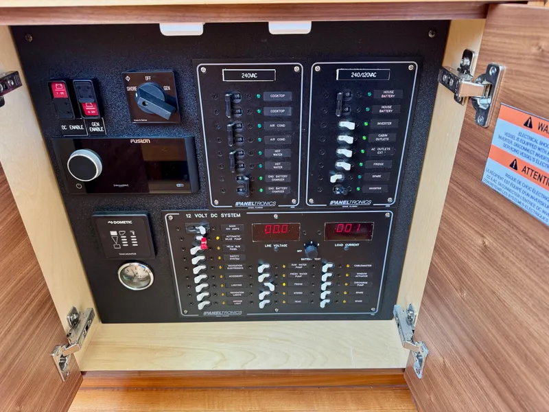 Slide: The Image of Electrical control panel inside 2020 Coastal Craft 33 Express boat, featuring switches and gauges. - 33