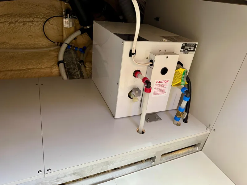 Slide: The Image of Engine compartment of 2020 Coastal Craft 33 Express boat, featuring mechanical components and wiring. - 34