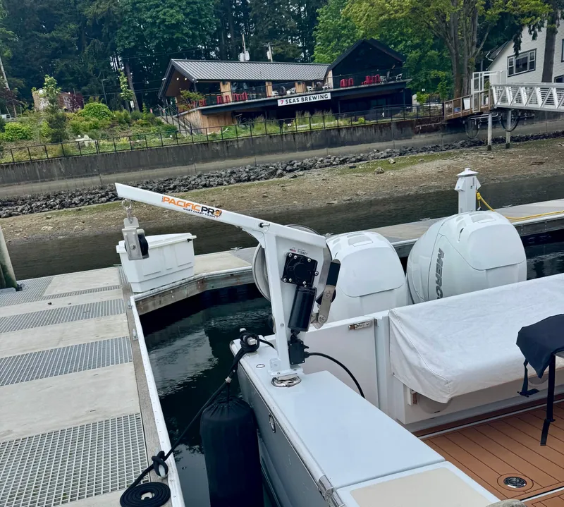 Slide: The Image of 2020 Coastal Craft 33 Express docked near a scenic waterfront restaurant. - 5