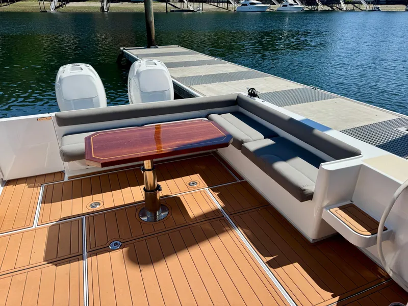 Slide: The Image of 2020 Coastal Craft 33 Express boat with teak deck and seating area by the dock. - 8
