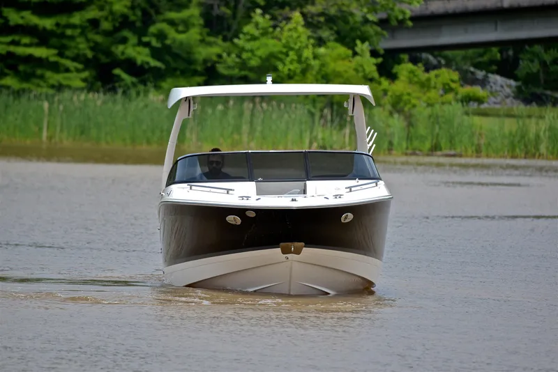 Slide: The Image of 2022 Regal LS4 boat cruising on a calm river with lush greenery in the background. - 12