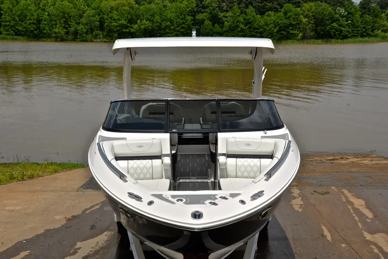 Slide: The Image of 2022 Regal LS4 boat on a ramp by a lake, surrounded by greenery. - 20