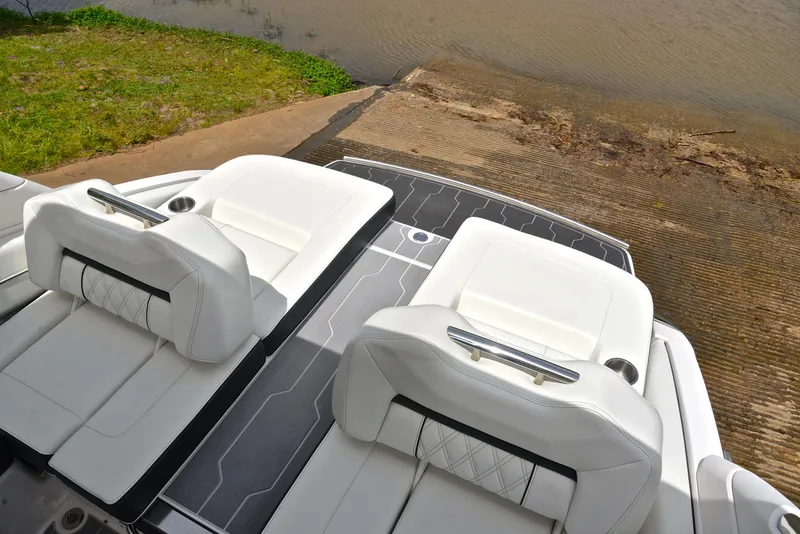 Slide: The Image of 2022 Regal LS4 boat with white leather seats and sleek deck design near water. - 27