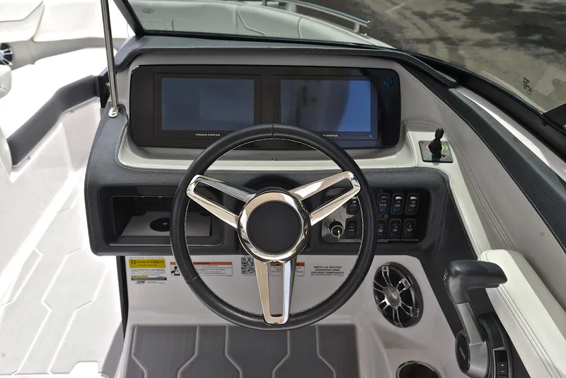 Slide: The Image of 2022 Regal LS4 boat dashboard with steering wheel and control panel. - 29