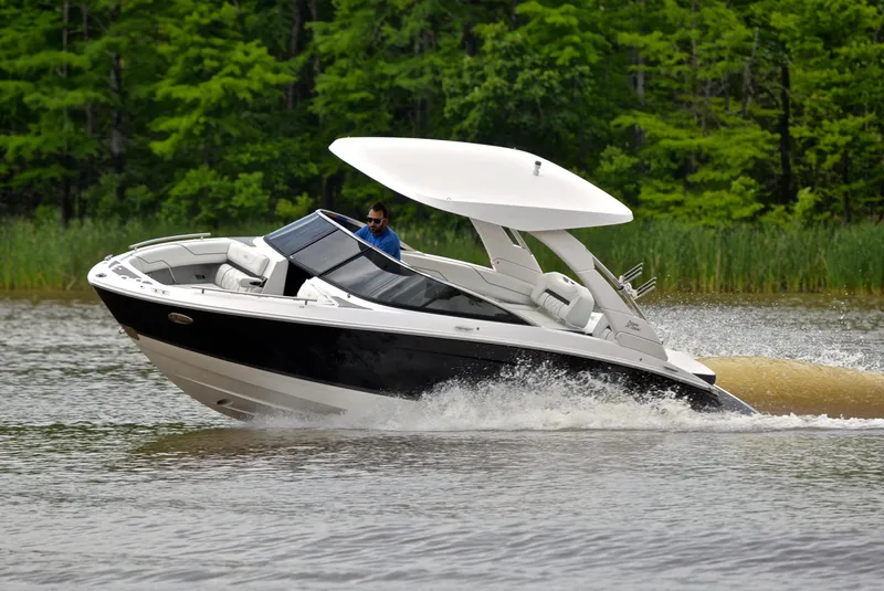 Slide: The Image of 2022 Regal LS4 boat cruising on a lake with lush green trees in the background. - 8